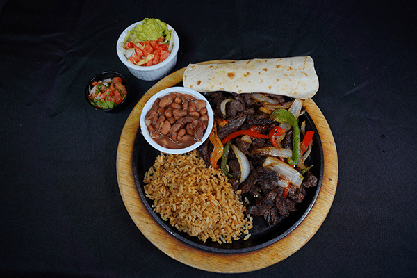Fajitas with rice, beans, and guacamole