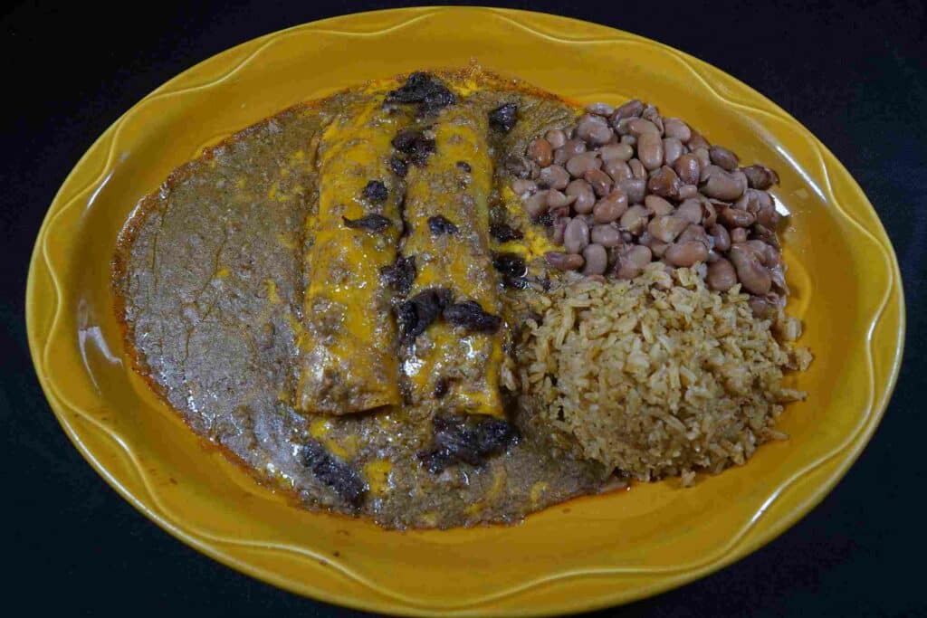 Plate of enchiladas, rice, and beans