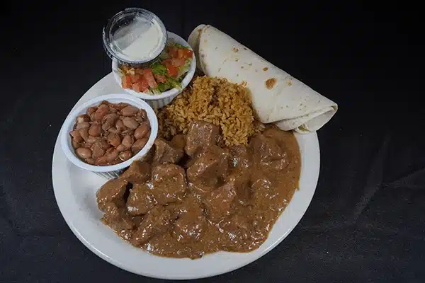 Beef stew with rice, beans, and a burrito
