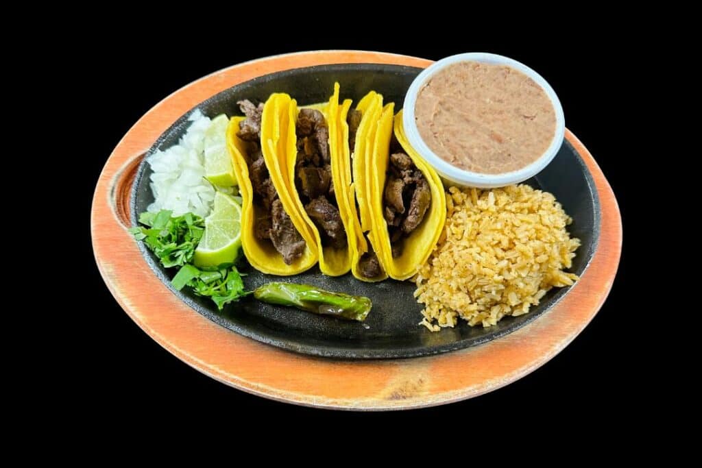 Fajita tacos with rice and beans on a plate