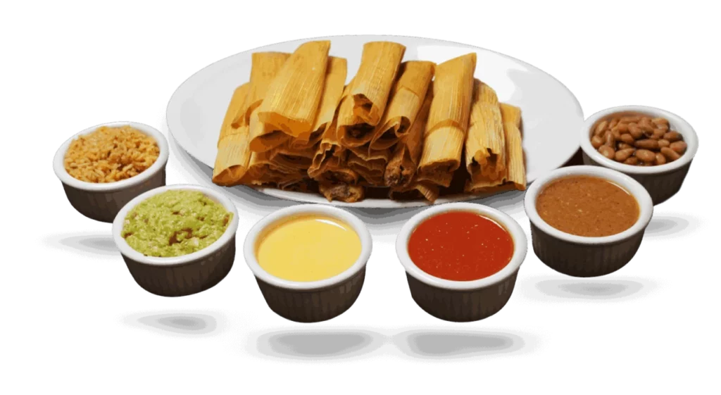 Plate of traditional Mexican tamales surrounded by bowls of different sauces. Available w/ Yoakum TX catering