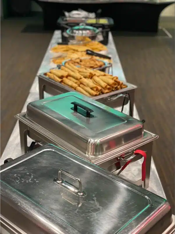 A buffet table with various dishes.