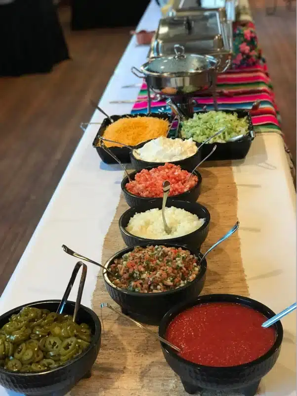 A buffet table with various condiments.