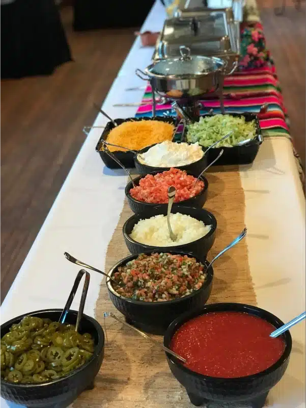 Mexican toppings and salsa on table.