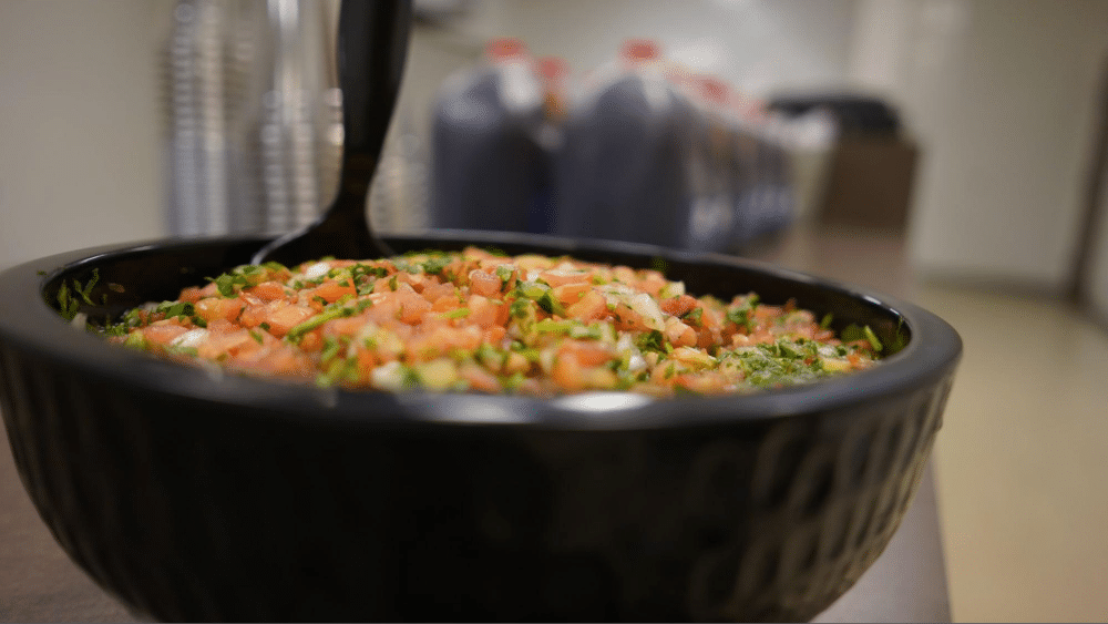 Close-up of pico de gallo in a black bowl.