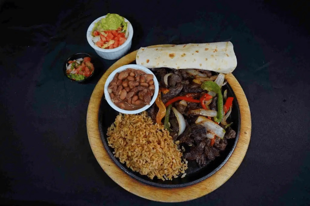 Fajita plate with rice and beans.